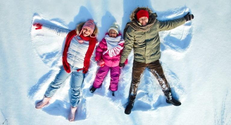 family making snow angels, winter break activities