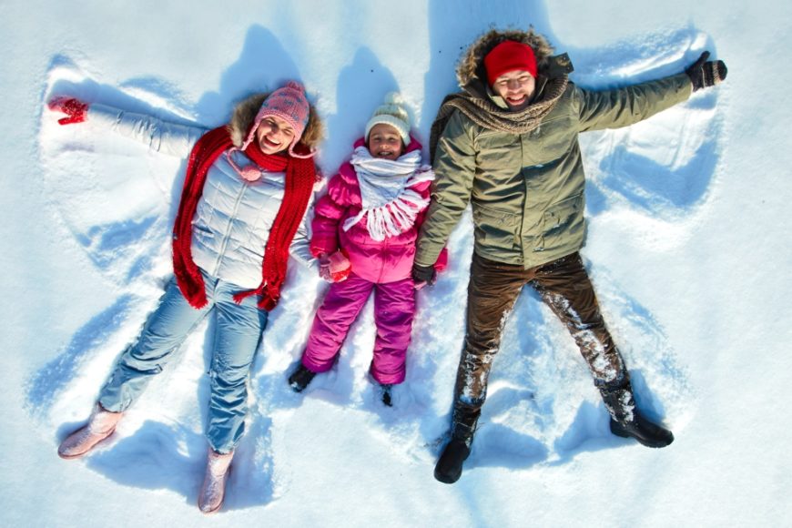 family making snow angels, winter break activities