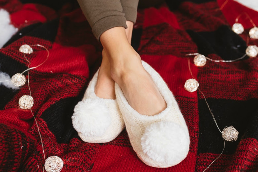 cozy white slippers on red and black buffalo plaid blanket