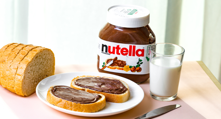 jar of nutella with toast and a glass of milk