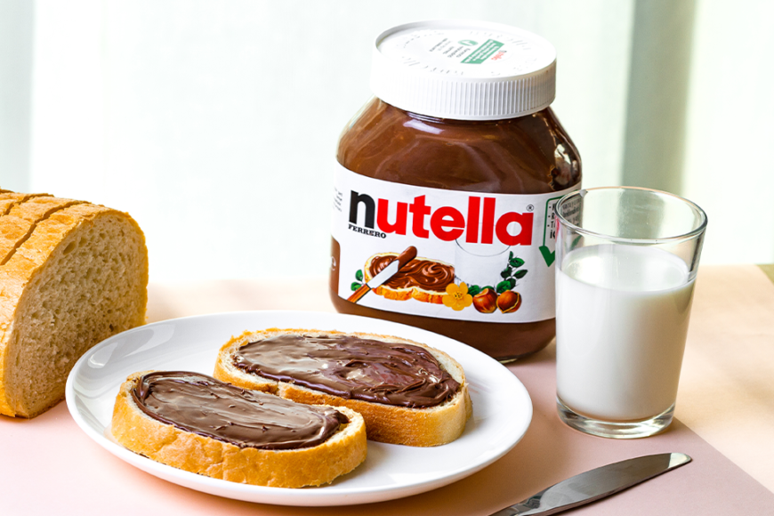 jar of nutella with toast and a glass of milk